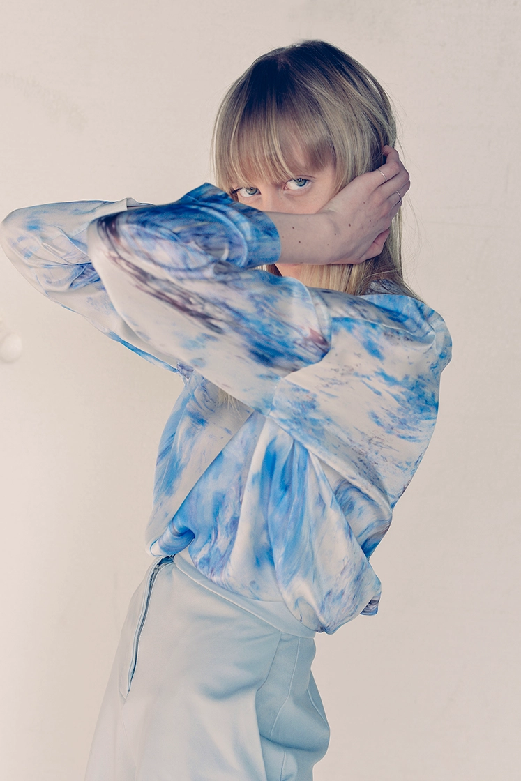 female model hiding her face with her arms