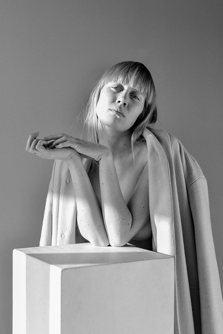 female model leaning on wood black and white