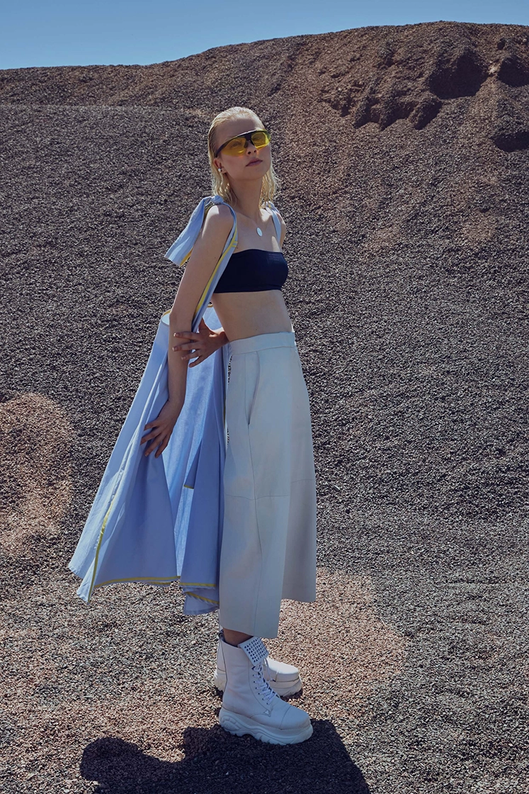 female model standing in front of hill